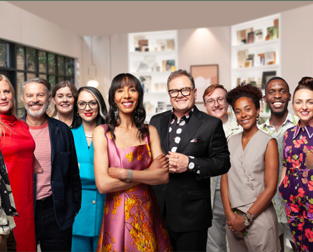 Alan Carr and Michelle Ogundehin stand with the contestants of the BBC show Interior Design Masters